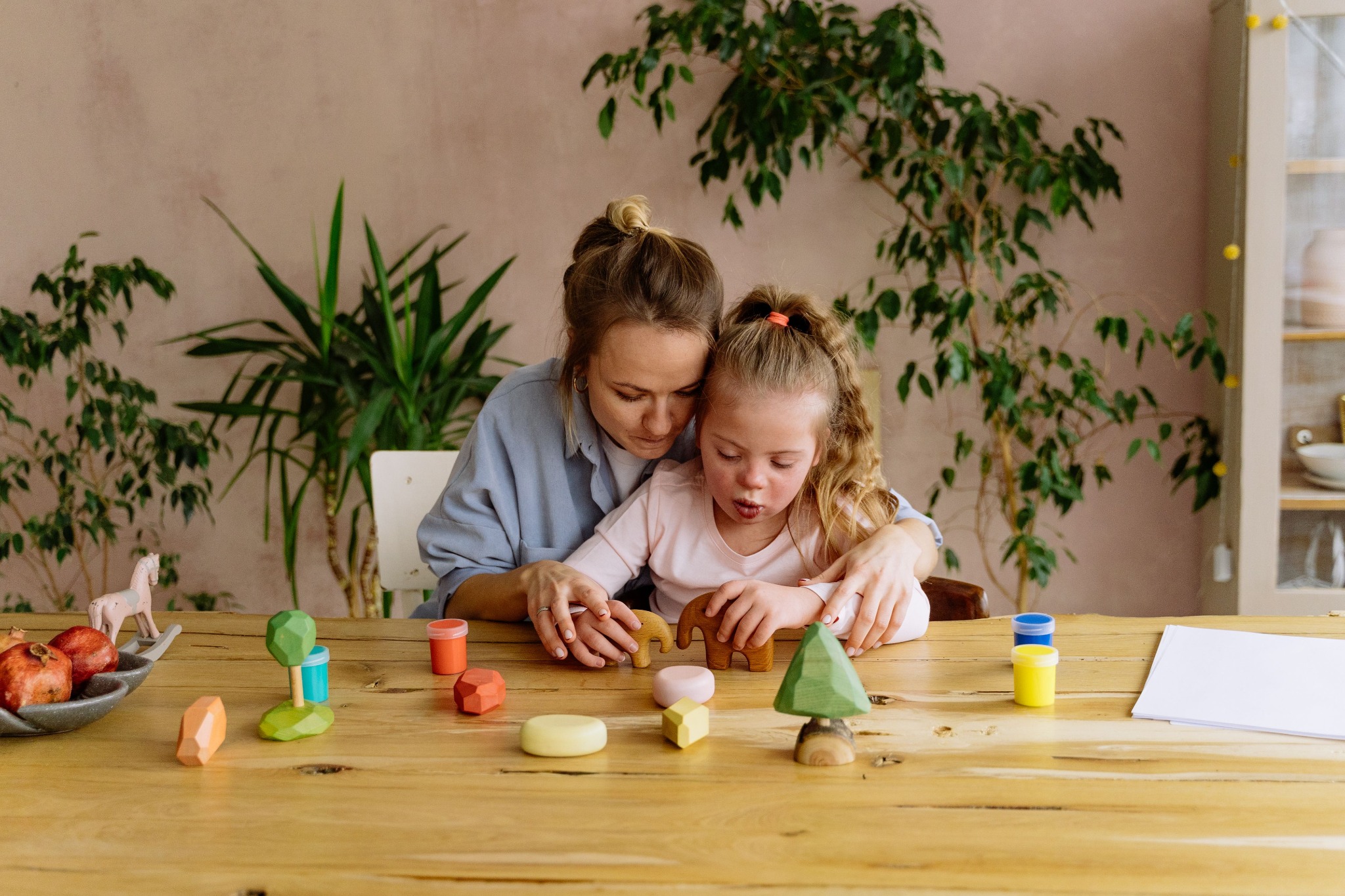 Adult supporting a child during a play-based activity at home