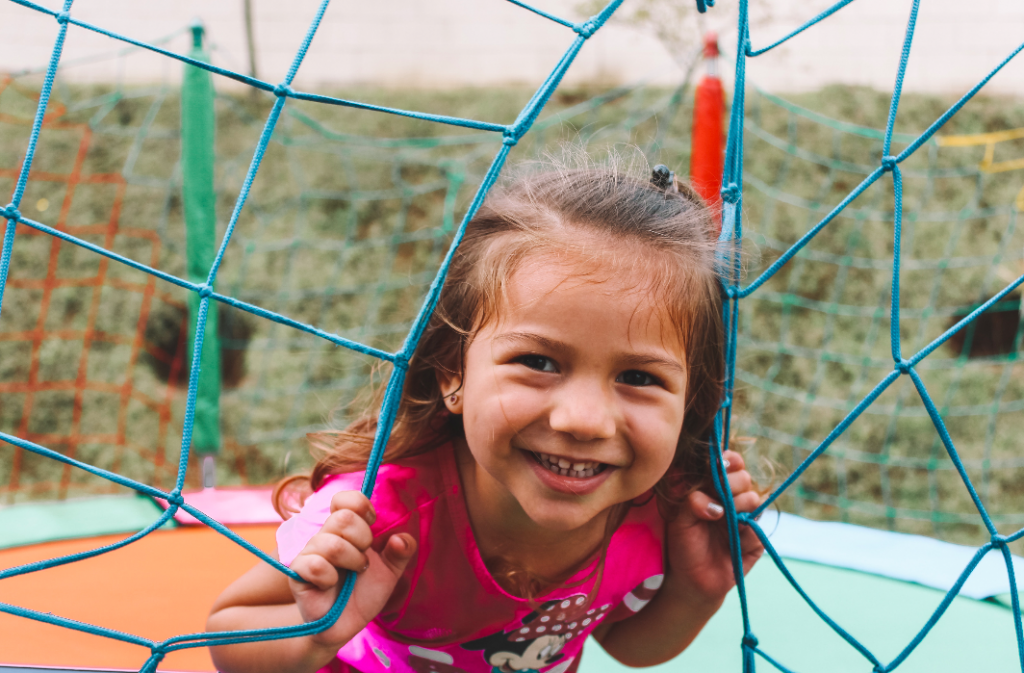 child smilling and playing outside