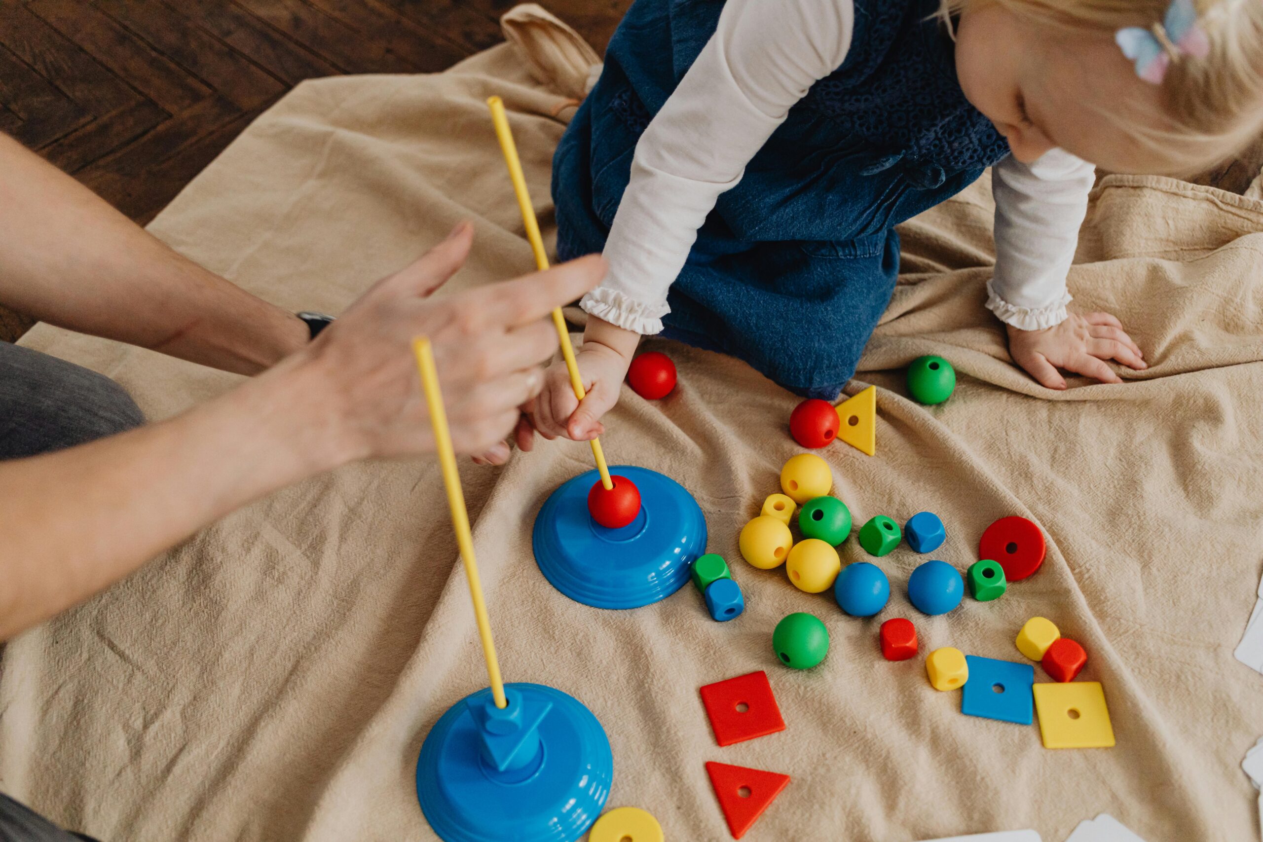 Pediatric SLP performing a speech and language assessment for toddlers.